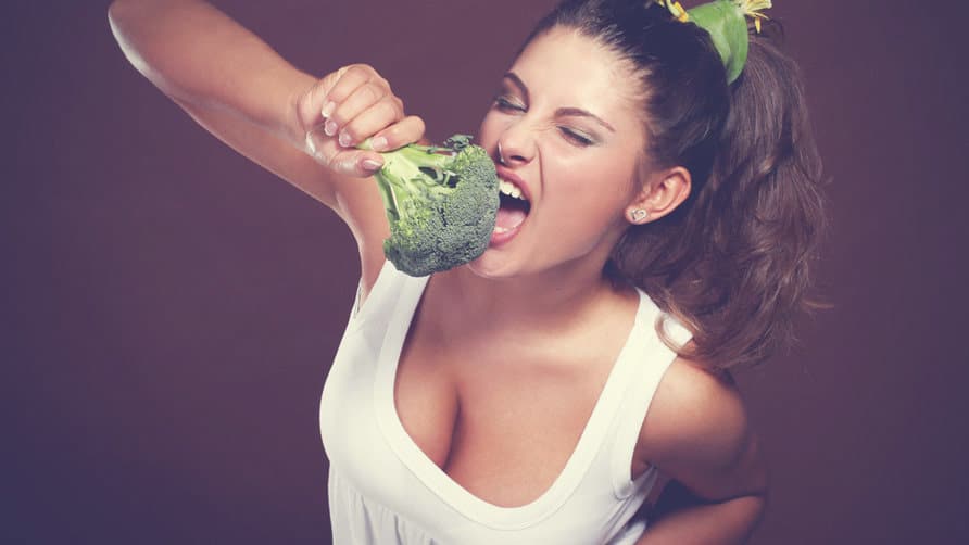 Girl-in-white-shirt-eating-broccoli