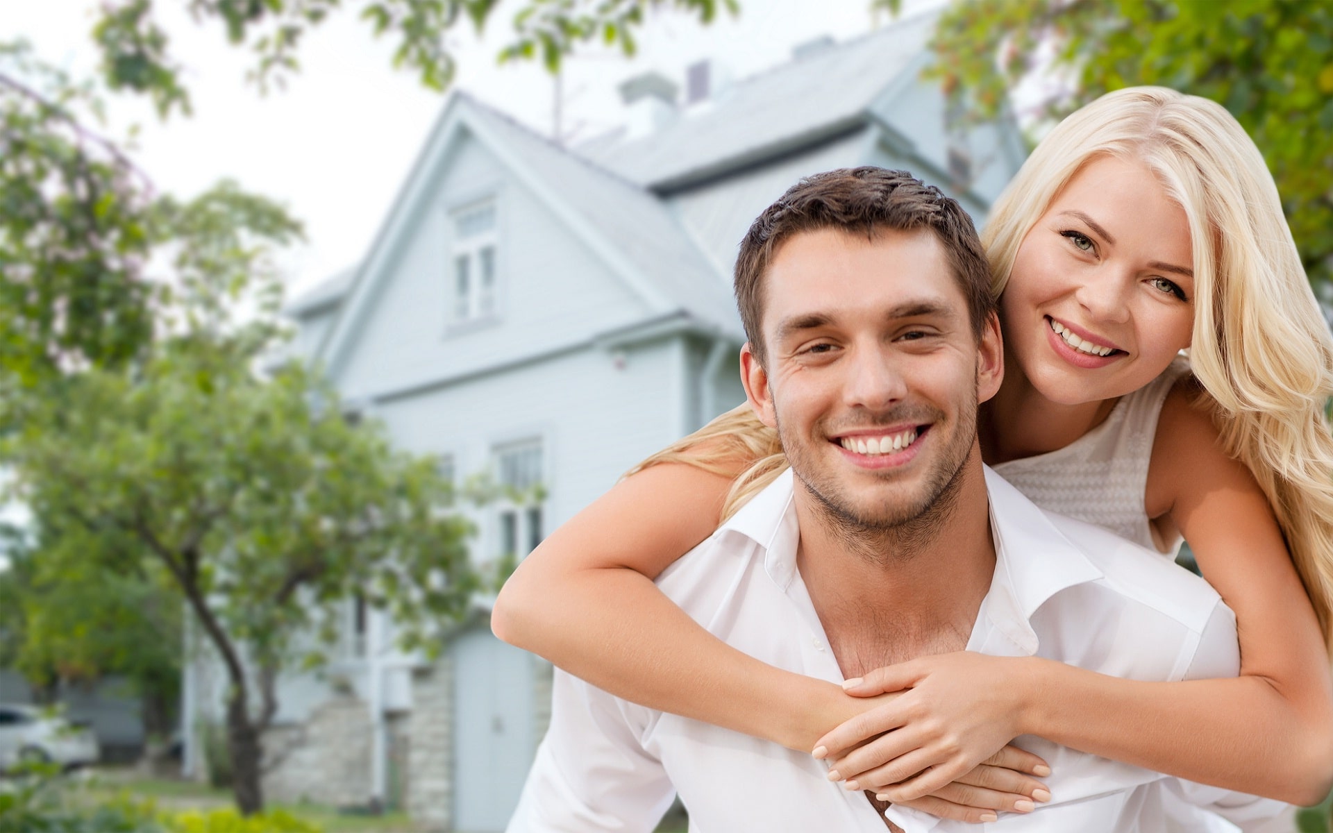 happy-couple-showing-affection-outside-their-house
