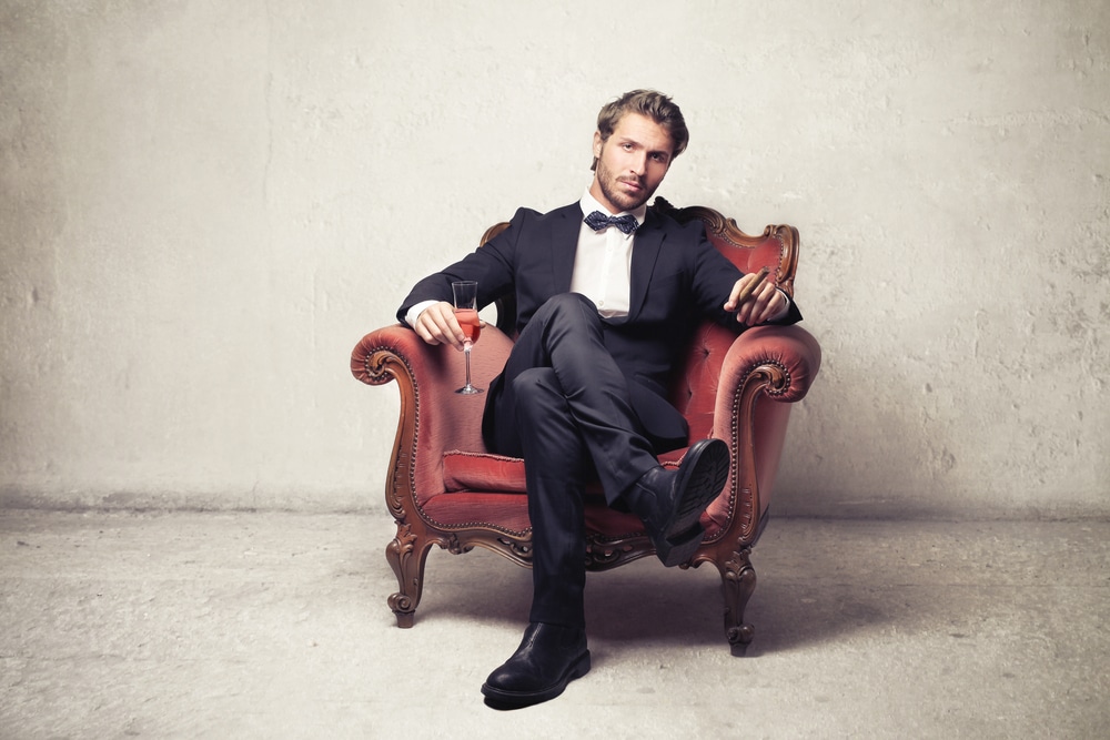 alpha male in a suit sitting down