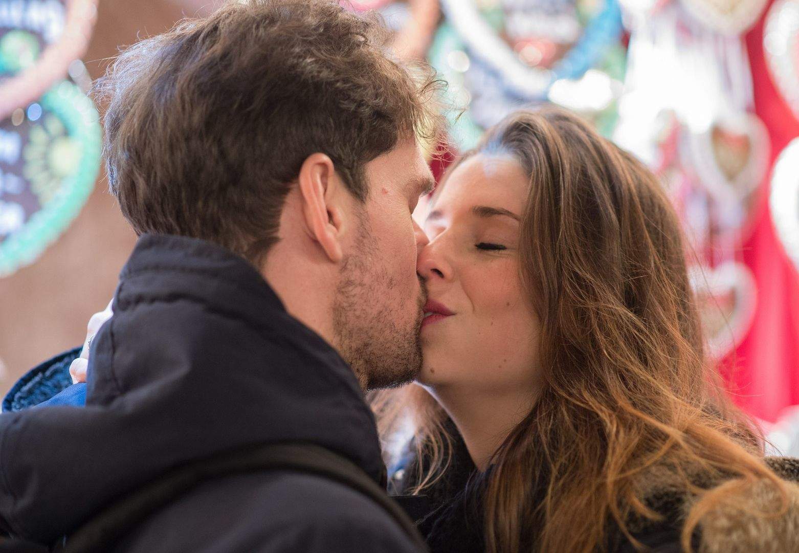 cute girl kissing shy guy